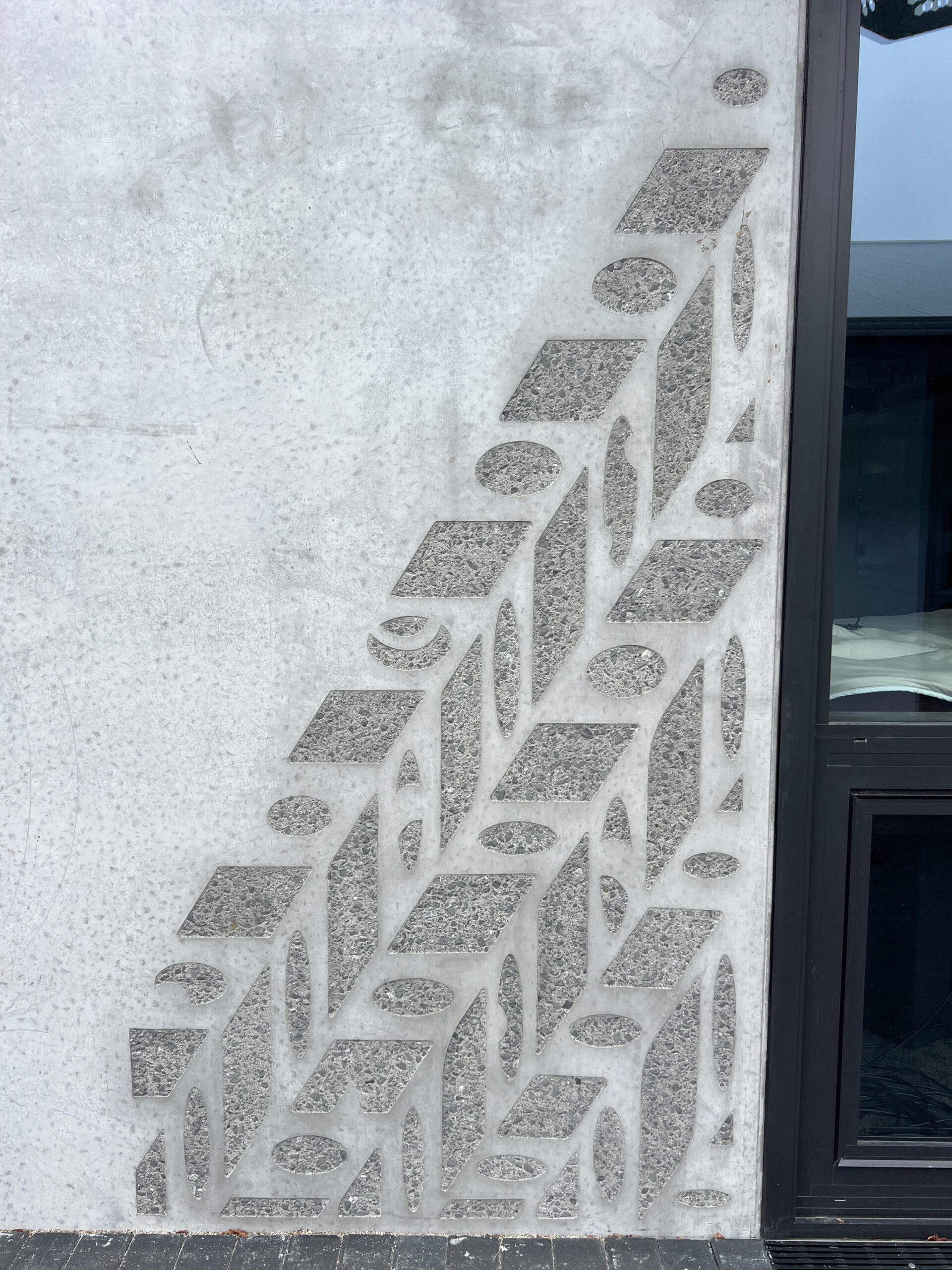 Sandblasted concrete artwork enhanced with ECOTONE Matt wash, Cambridge High School
